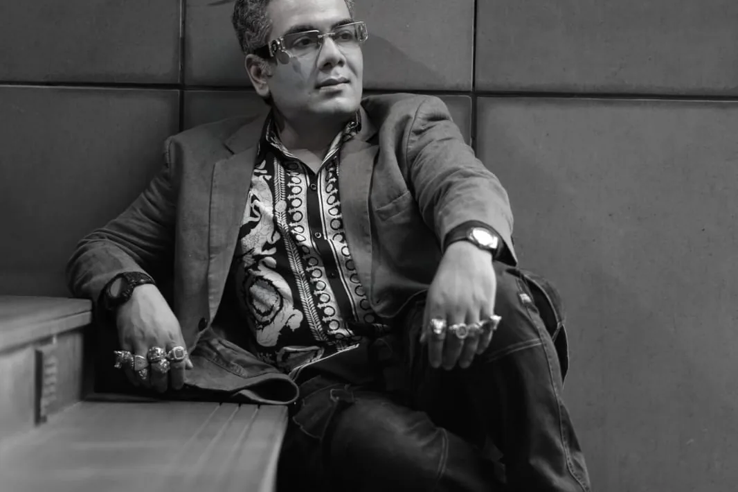 Sudeep Ranjan Sarkar seated on a flight of steps in Kolkata, photographed in black and white