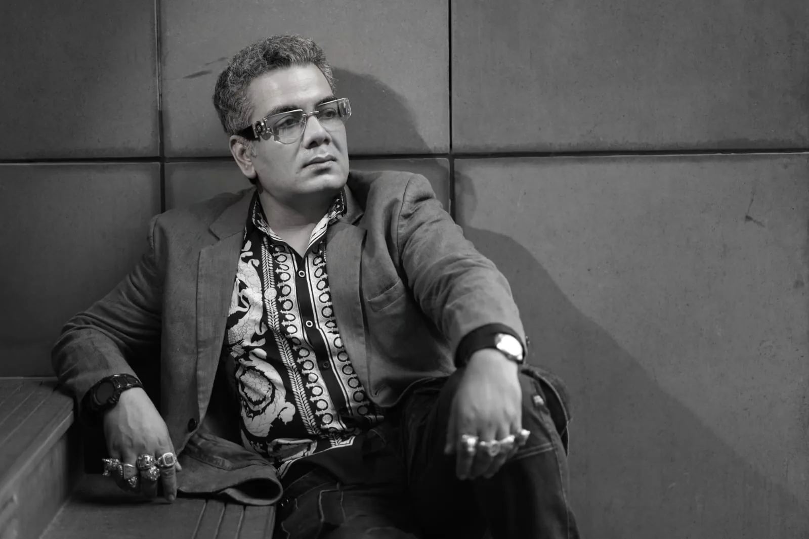 Sudeep Ranjan Sarkar seated on stone steps, black and white
