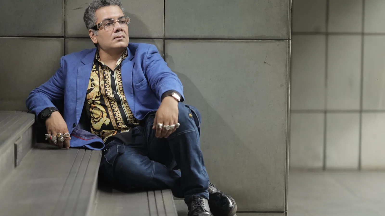 Sudeep Ranjan Sarkar seated on stone steps outside a building in Kolkata